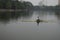 Lone rower rowing his boat in the dusk at rabindra sarobar lake, kolkata