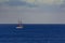 Lone Sail Ship on a blue, clear horizon, calm ocean