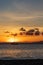 Lone sailboat anchored in a Maui Channel during a picturesque Hawaiian sunset