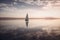 a lone sailboat floating in the middle of a lake