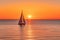 A Lone Sailboat in a Serene Sunset Over Calm Ocean Waters