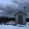 Lone shack under a gray sky