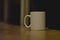 A lone single coffee cup in the dark window