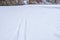 A lone ski track on fresh snow going into the distance