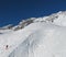 Lone skier sidestepping up ski slope