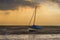 A lone small boat beached at Morston Creek, Norfolk at low tide just before sunset