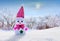 Lone snowman on winter landscape background during sunset_