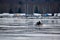 Lone snowmobile on a frozen lake