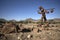 Lone stone man of Kaokoland walking to a gathering at Marble. Kunene Region, Namibia. low angle.