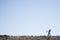 Lone stone man of Kaokoland walking to a gathering at Marble. Kunene Region, Namibia. low angle of the statue that is a mystery.