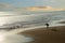 Lone surfer exercising on empty beach