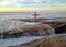 Lone Surfer looks out into the Pacific Ocean