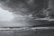 Lone surfer walks into the ocean to catch a wave. Portugal.