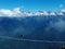 a lone thrill-seeker on the suspension bridge in the mountains