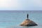 A lone tourist on a rock looks at the sea of Karidi in Greece