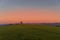 A lone tree on a hill and a family who decided to fly an artificial kite timelapse during the autumn sunset, capturing the sunset