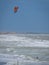 Lone unrecognizable kiter in the stormy sea on the beach of Marina di San Nicola in Italy