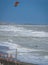 Lone unrecognizable kiter in the stormy sea on the beach of Marina di San Nicola in Italy