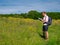 A lone walker in a field of wild flowers