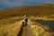 A lone walker on a mountain path