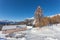 Lone walker who passes near a hut surrounded by a fantastic winter environment