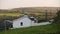 A lone white house in rolling Irish fields