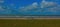 Loneliness, abandoned bench on a lawn with a view of the North Sea