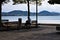 The loneliness of an isolated man sitting on the bench in front of the Trasimeno Lake Umbria, Italy