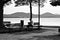 The loneliness of an isolated man sitting on the bench in front of the Trasimeno Lake Umbria, Italy