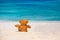 Loneliness Teddy Bear sitting on the beach.