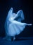 Loneliness. Young graceful beautiful woman, balerina in white wedding dress in art performance.
