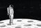 Lonely astronaut in spacesuit standing on surface of Moon and looking at space full of stars. Cosmonaut exploring planet
