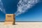 Lonely beach chair facing the ocean under beautiful blue sky