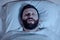 A lonely bearded man sleeps at night with his mouth open, snoring. Apnea syndrome, bedroom, pajamas, white bedding