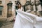 Lonely beautiful bride in a white dress walking in old city. wedding concept