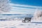 A lonely bench in a calm winter landscape