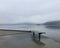 Lonely bench on foggy lake