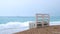 A lonely bench stands on the shore of the sea beach.