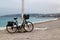 Lonely bicycle on beach on cloudy rainy day