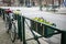 Lonely bicycle parked near the weathered fence with flowers