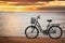 Lonely bike standing at sunset at seaside