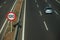 Lonely blue car on highway and SPEED LIMIT signpost in Madrid