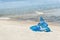 Lonely blue inflatable dolphin on the beach.