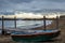 A lonely boat on the beach of Castiglioncello in Tuscany in winter at sunset with a island on the horizon - 6