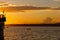 Lonely boat with fishermen in the sea against the backdrop of a bright sunset in Vladivostok