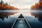 A lonely boat rest on tranquil and glassy lake with beautiful and colorful landscape with Fall foliage.