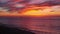 Lonely boat at sea and dramatic sunset on the empty beach