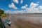 A lonely boat sits on the river Mersey waiting for the tide to come back