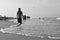 A lonely boy walking in the beach alone, black and white image