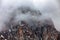 lonely brutal rock among the descending clouds. View from Chimbulak